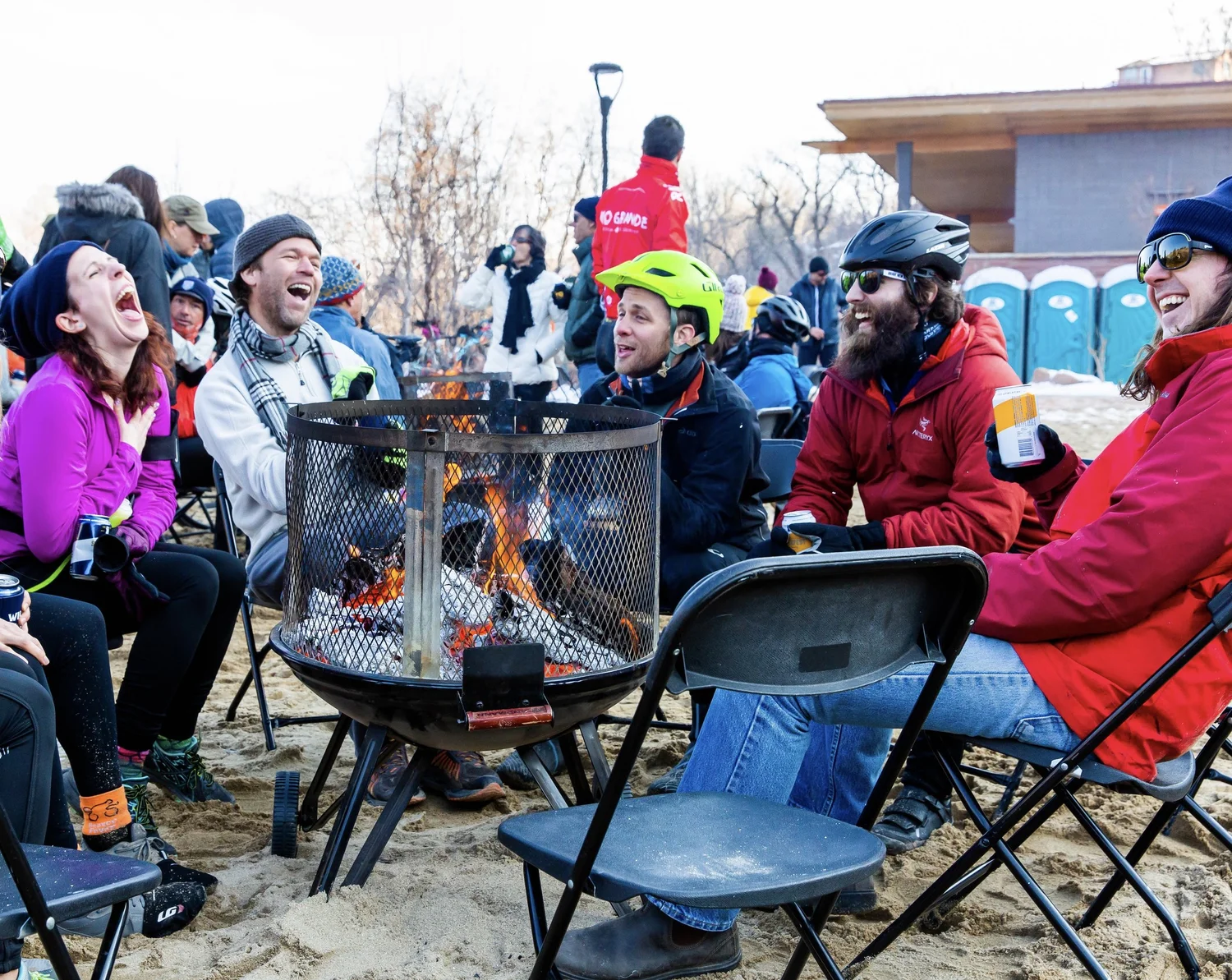Friends gathering around a finish-line bonfire
